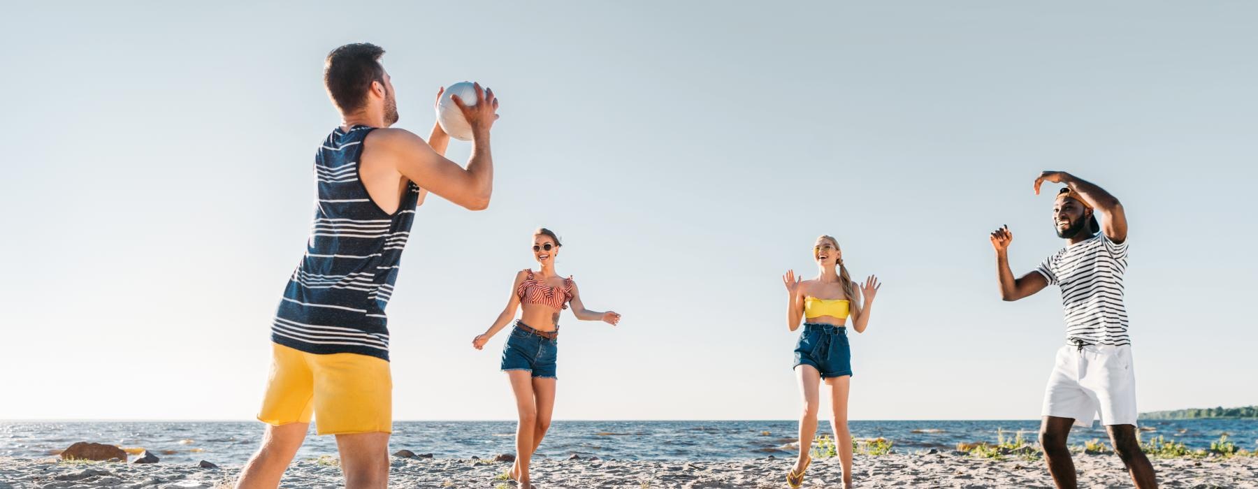 a group of people playing on a beach