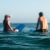 a couple of people surfing in the sea